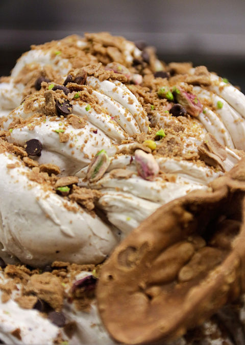 Gelato bianco con biscotti sbriciolati, gocce di cioccolato e pistacchi