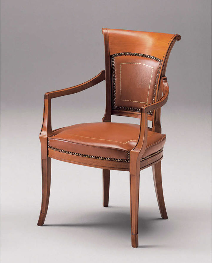 Wooden dining armchair with upholstered seat and back in brown leather.