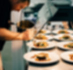 A chef plating food at a restaurant