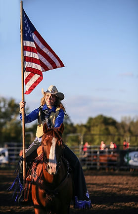 Woman on a horse holding an US flag