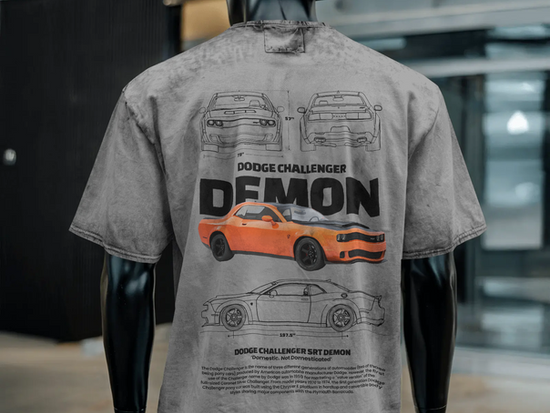 Rear view of a male mannequin dressed in an oversized printed T-shirt, highlighting the back graphic design and loose, comfortable fit against a neutral background.