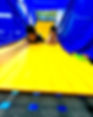 Happy children playing on a yellow playground slide