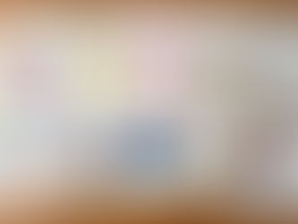 Ten handmade birthday cards with cake, balloon, and candle designs arranged on a wooden surface.