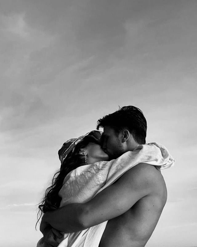 Black and white photograph of a female and male couple kissing