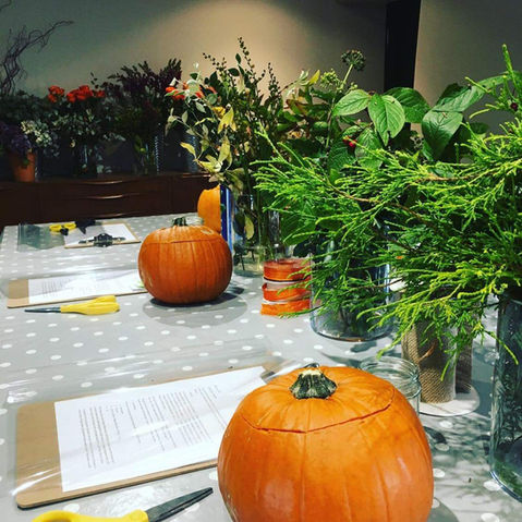 Floral autumn display in a pumpkin vase