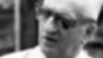 Enzo Ferrari looks disgruntled while wearing sunglasses