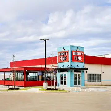 Full plumbing installation at Mighty Fine Burgers in Kyle, displaying rough-in work, utility lines, and fixture connections completed from initial dig to final inspection.