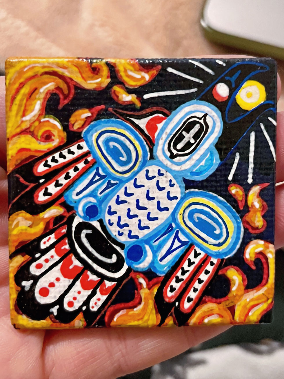 Painting of a raven and fire in folk art style.