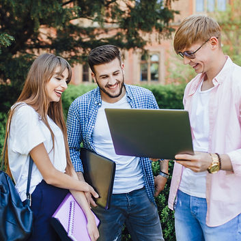 three-students-stylish-clothes-look-laptop-laugh-university-campus-scaled.jpg