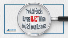 Magnifying glass highlights text: "The Add-Backs Buyers REJECT When You Sell Your Business." Logo: Hartmann Rhodes, M&A Advisors.