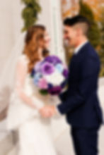 A bride and groom pose in front of the Mount Timpanogos Temple after their Temple Exit