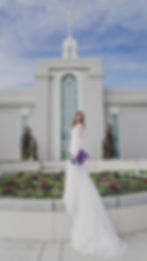 A bride and groom pose in front of the Mount Timpanogos Temple after their Temple Exit