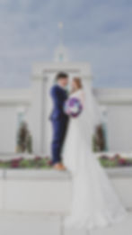 A bride and groom pose in front of the Mount Timpanogos Temple after their Temple Exit
