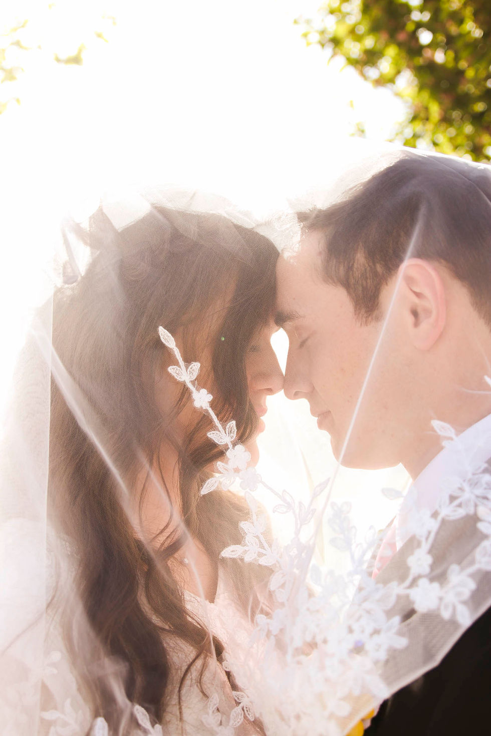 A bride and groom touch heads