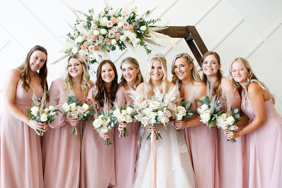A beautiful bride and her bridesmaid pose for pictures at the Azalea Event Venue in Daybreak Utah