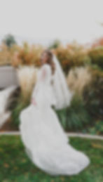 A bride twirls in her dress in front of the Mount Timpanogos Temple after their Temple Exit