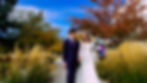 A bride and groom pose in front of the Mount Timpanogos Temple after their Temple Exit