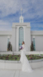 A bride and groom pose in front of the Mount Timpanogos Temple after their Temple Exit