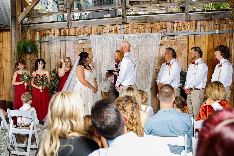 a wedding ceremony inside a barn