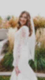 A bride twirls in her dress in front of the Mount Timpanogos Temple after their Temple Exit
