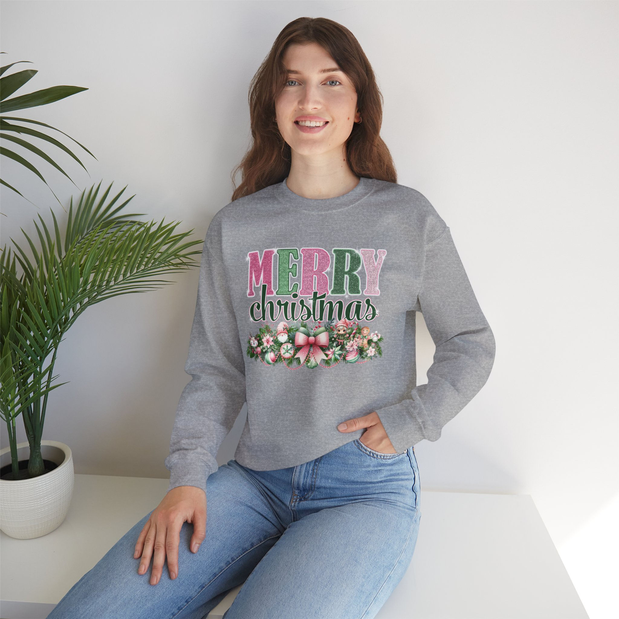 Woman wearing gray sweatshirt with Merry Christmas text and floral design