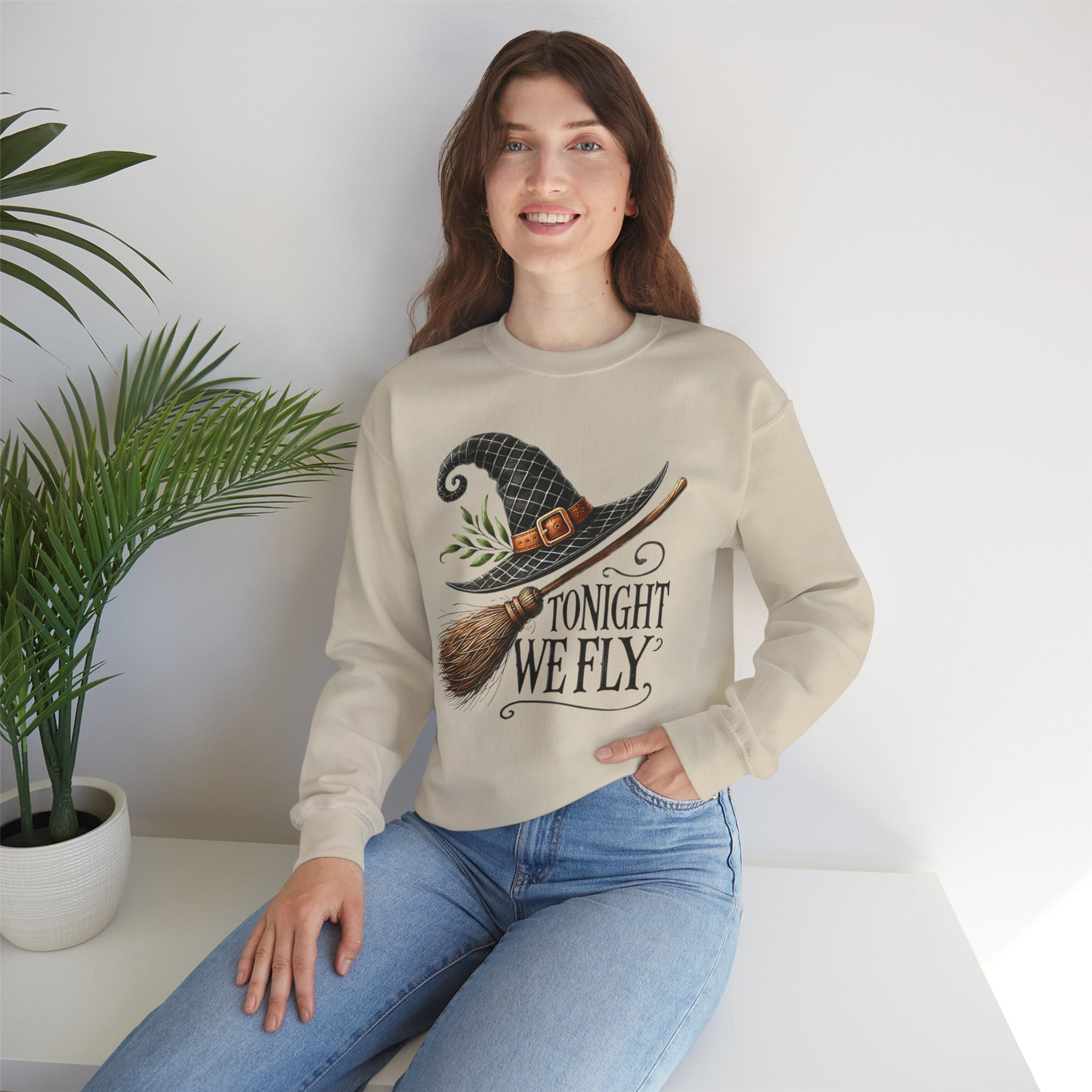 Woman wearing "TONIGHT WE FLY" hat, Lacey Spooky Season Unisex Heavy Blend™ Crewneck Sweatshirt.