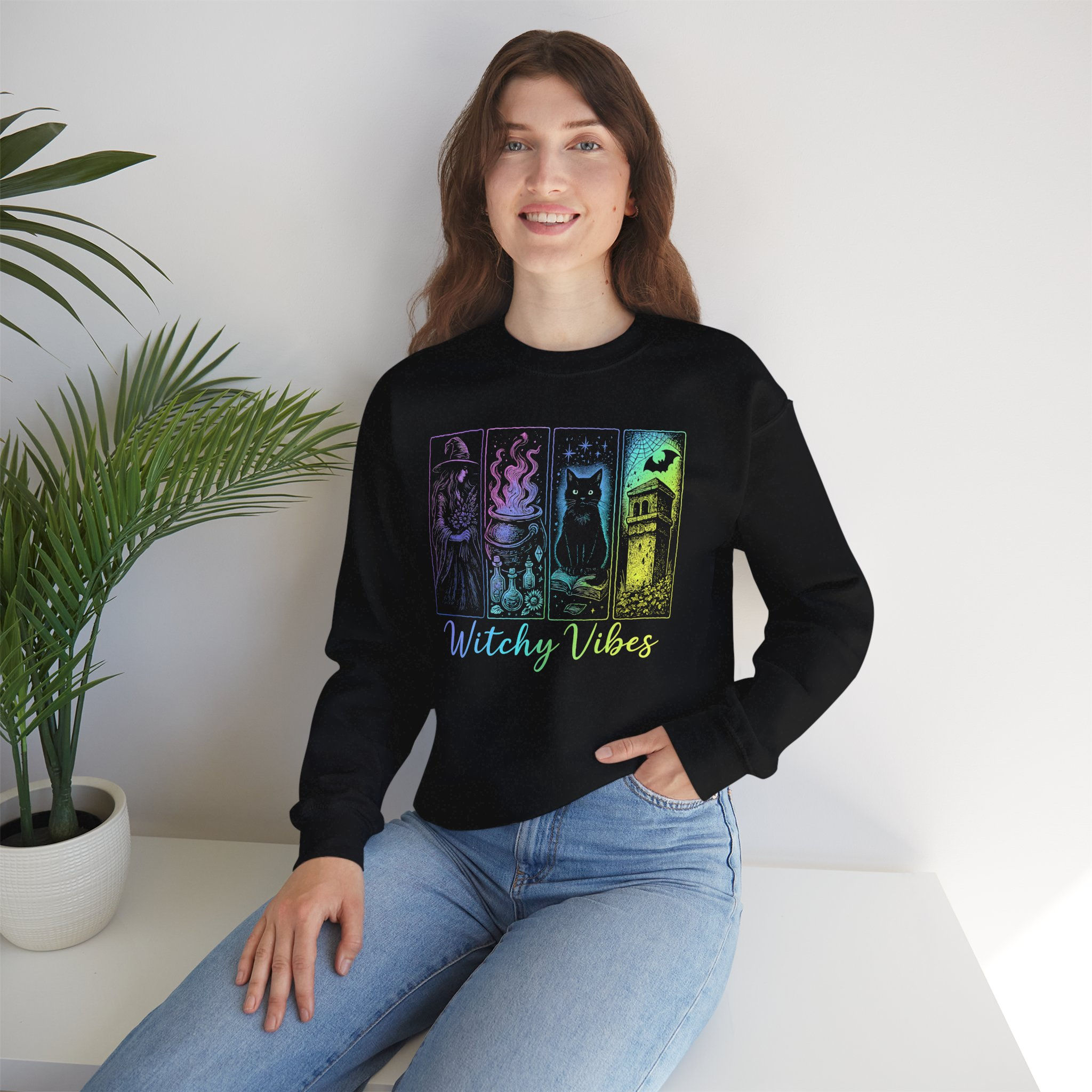 Woman wearing black sweatshirt with witchy vibes design in a room