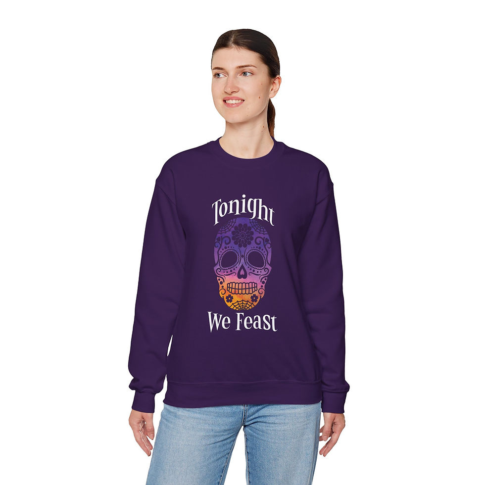 Thumbnail: Woman wearing purple Tonight We Feast skull sweatshirt, smiling at the camera.