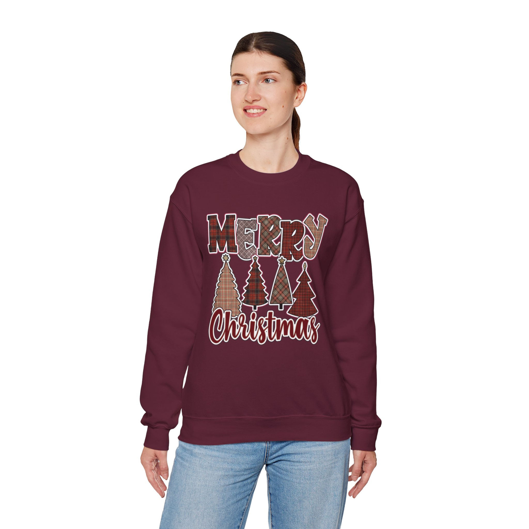 Woman wearing Merry Christmas sweatshirt with pastel trees, smiling, cheerful expression.