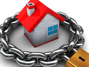 A small house encircled by a chain with a padlock
