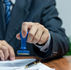 A document and pen with a blue rubber stamp