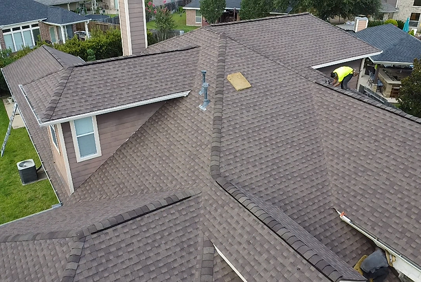 Aerial view of a new shingle roof installed by Home Restorer P&G on a Katy, TX home