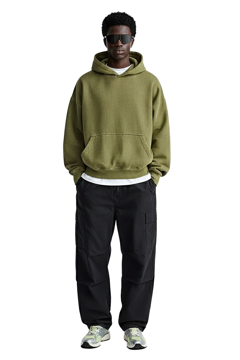 Man in olive hoodie, black pants, sunglasses and Drift Layer tee.