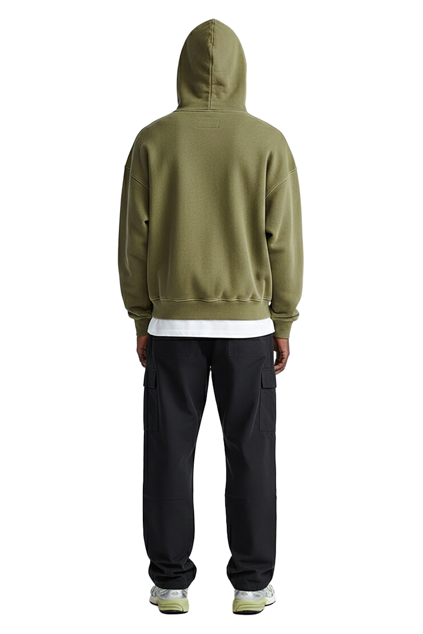 Man wearing green hoodie and black pants with white tee, back view.