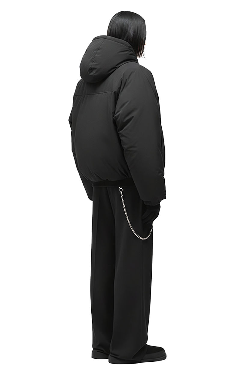 Man in black jacket and pants, side view, on black background.