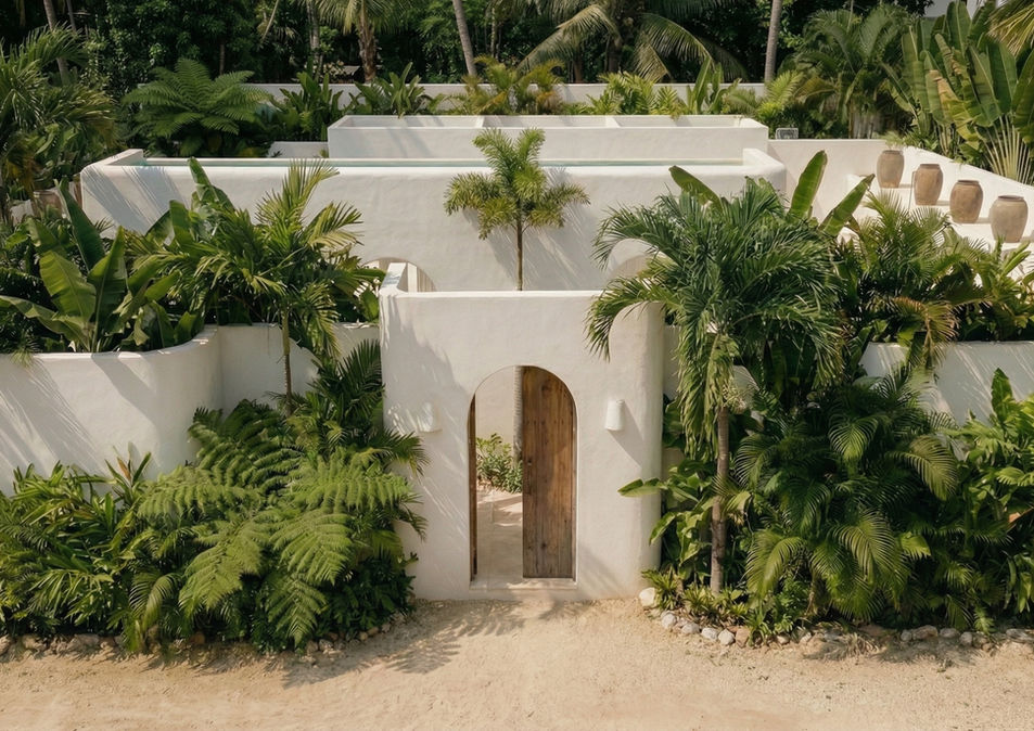 White tropical villa entrance with arched wooden gate.