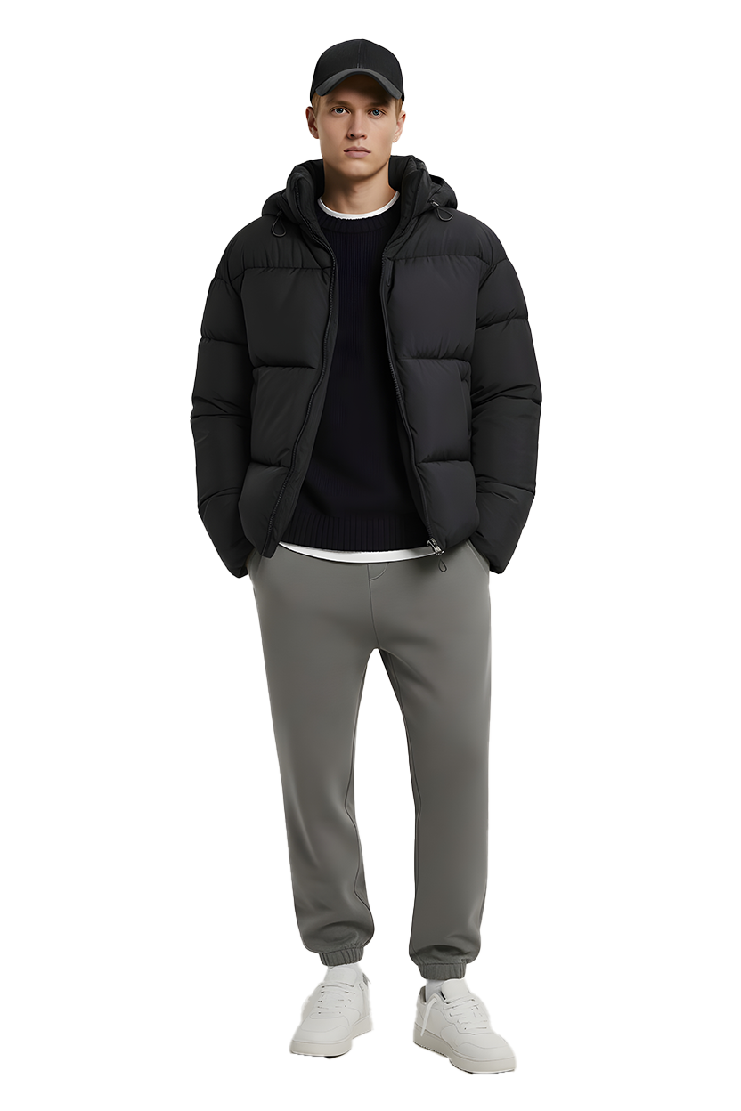 Man in black jacket, hat, and gray pants, white sneakers, full shot.