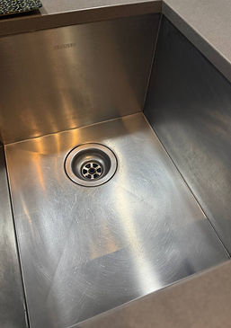 Shiny kitchen sink after thorough cleaning by Cleanphoria – spotless and polished.