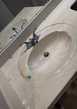 Dirty bathroom sink with soap stains and clutter — before Cleanphoria cleaning.