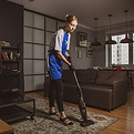 Residential Cleaning Cleaner vacuuming hallway in residential apartment building