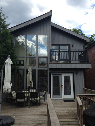 Leaside, Toronto - Exterior painting of a house in Leaside. The homeowner wanted to apply a solid stain to their wooden siding, trim, porch and newly built balcony.