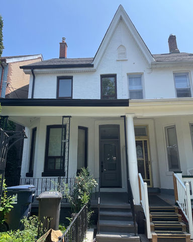 Downtown, Toronto - The brick was painted and the windows were sprayed. Metal fence and plastic siding were also sprayed. The narrow area required scaffolding to reach the peak.