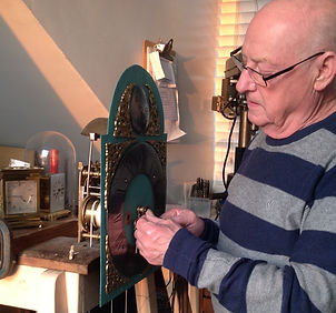 Man fixing a grandfather clock at our shop near St. Ives in Cambridgeshire