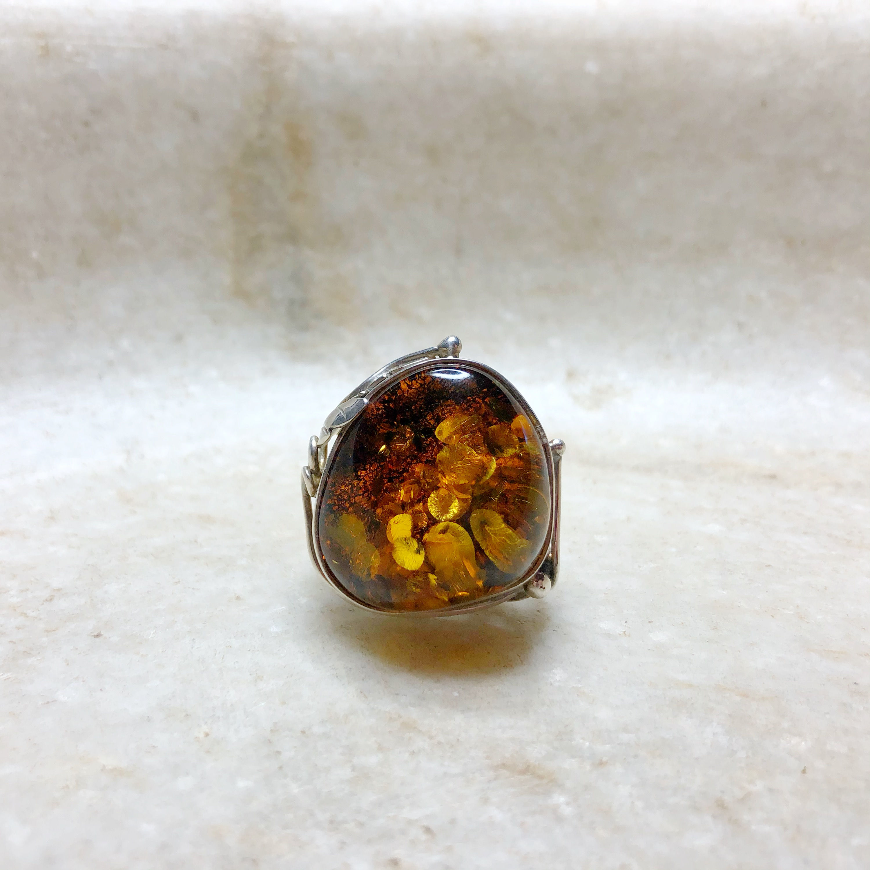 Large amber with silver leaf ring