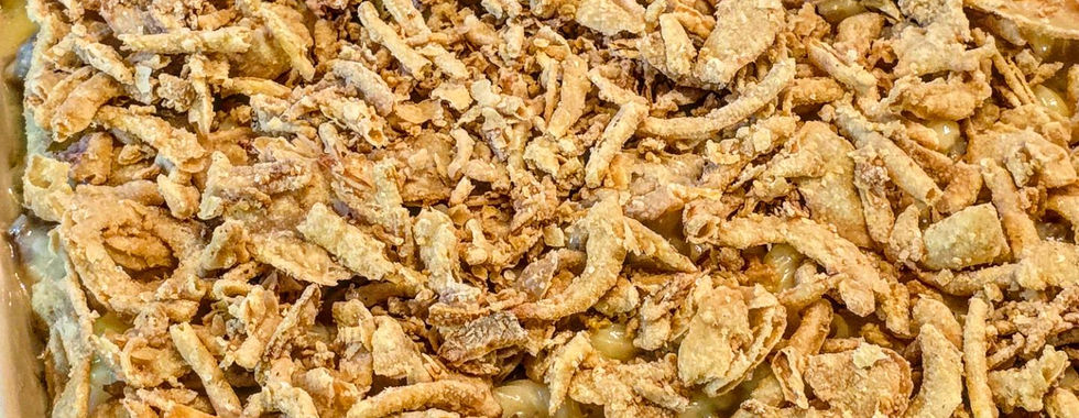 creamy macaroni and sausage bake with crispy fried onions on top that has not been baked yet.