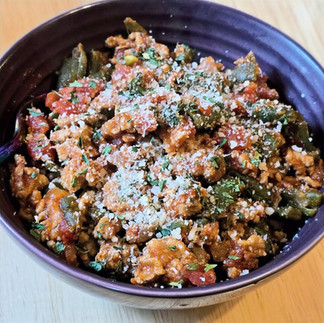 Ground Turkey and Green Bean Skillet plated inside of a purple bowl and garnished with parmesan cheese