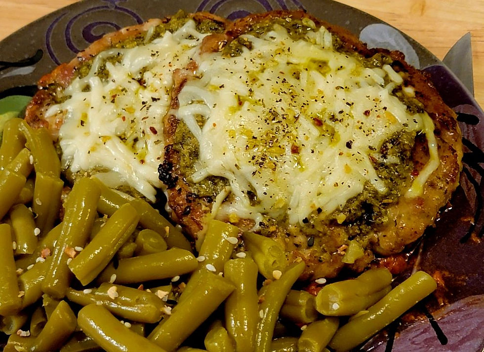 plated pesto mozzarella chicken patties with a vodka sauce reduction and green beans