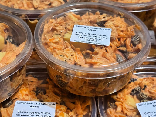 deli containers of carrot and raisin salad with apples