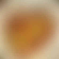 baked zucchini parmesan displayed sloppily on a white dinner plate