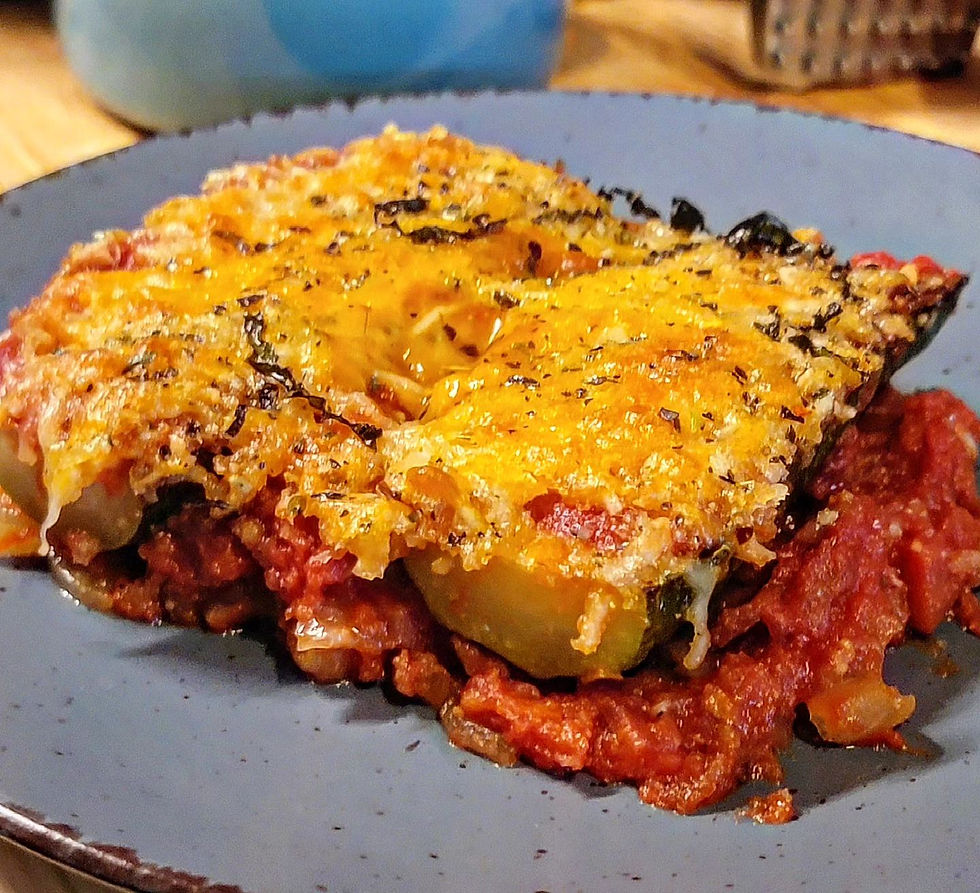 a serving of baked zucchini parmesan is displayed on a blue dinner plate